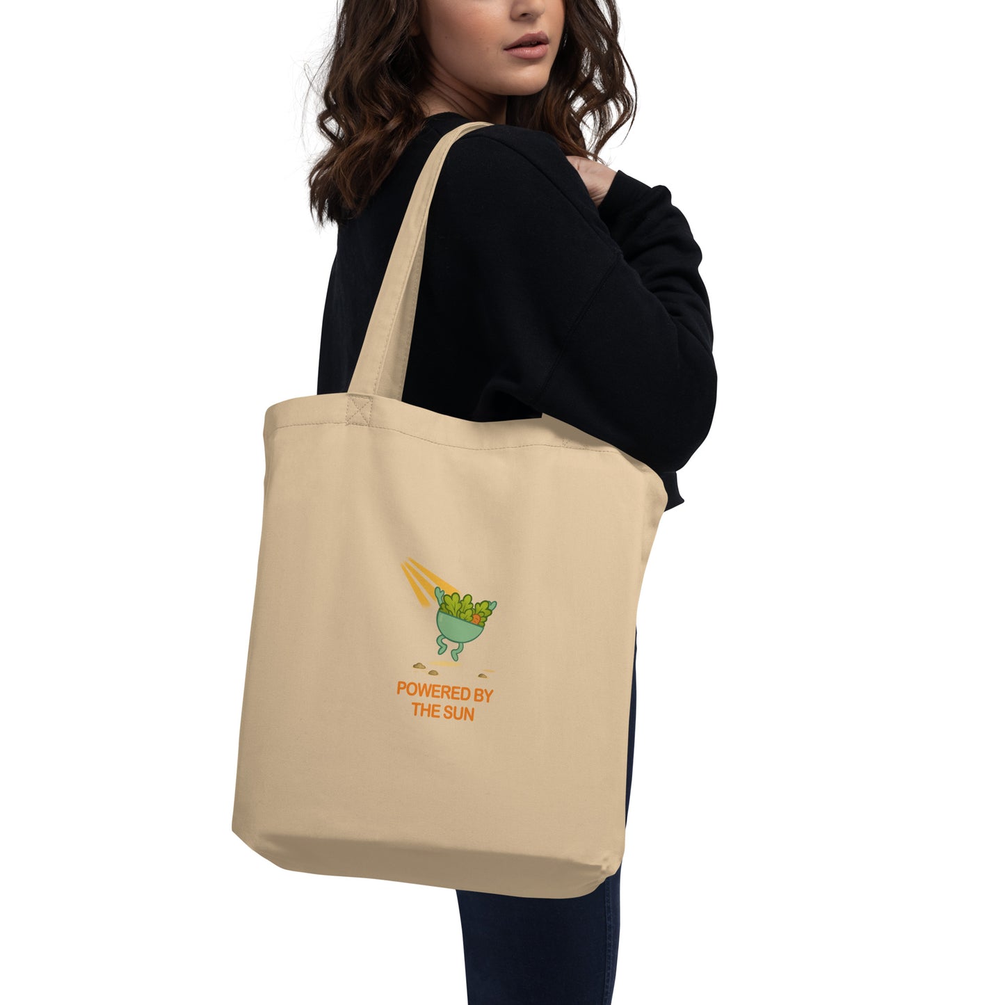 Back view of wid Designs eco tote bag in oyster color carried by a model.