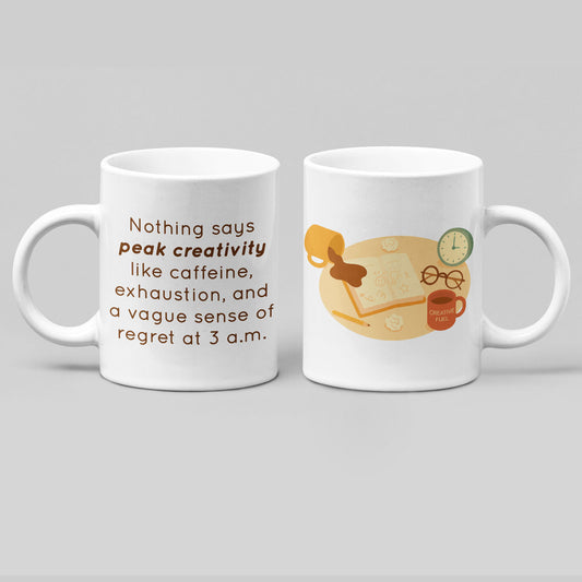 White ceramic mug featuring a humorous “peak creativity” quote on one side and an illustration of a messy late-night desk scene with coffee, notebooks, and a clock on the other, shown in a clean mockup for wid Designs.