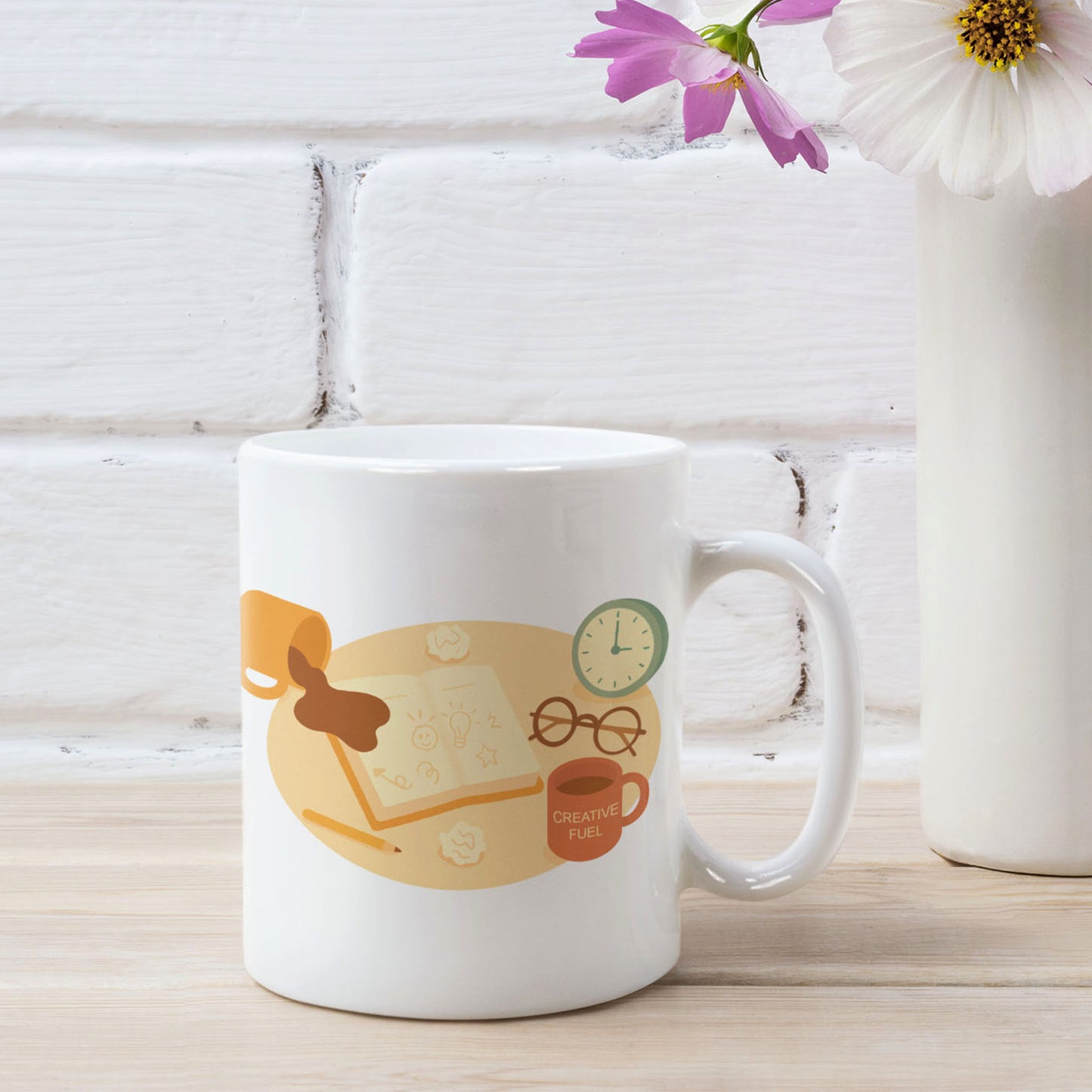 White ceramic mug featuring a playful late-night creativity illustration with coffee, notebooks, and a clock, shown in a styled product mockup with flowers and a white brick background for wid Designs.