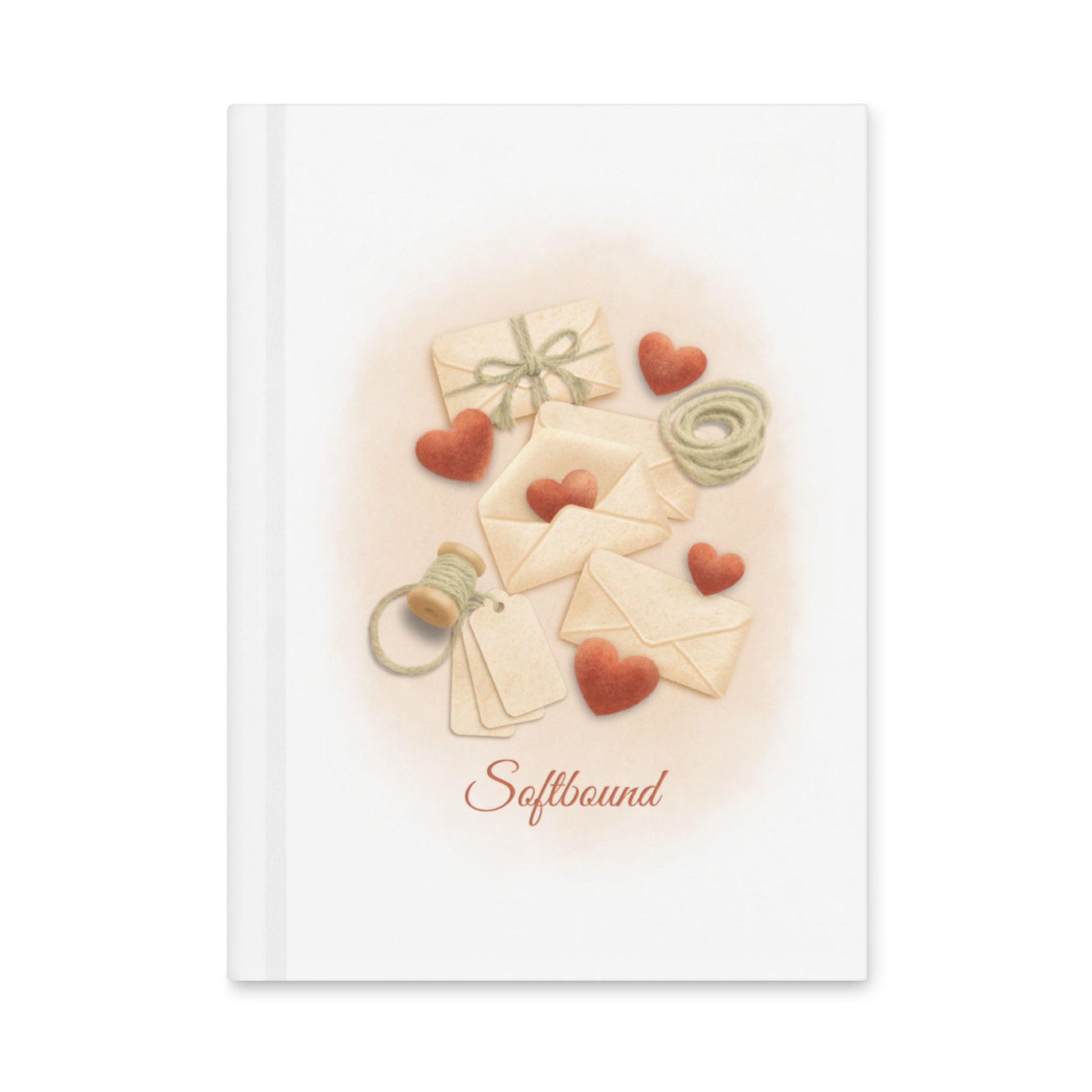 Matte hardcover journal mockup with a white cover featuring illustrated envelopes, felt hearts, twine, and the word “Softbound” centered below the artwork.