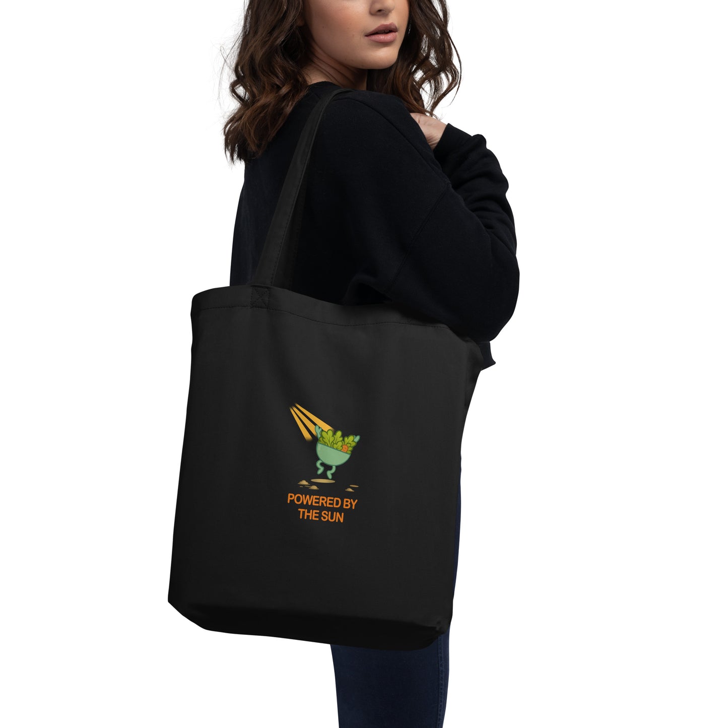 Back view of wid Designs eco tote bag in black, shown on a model.
