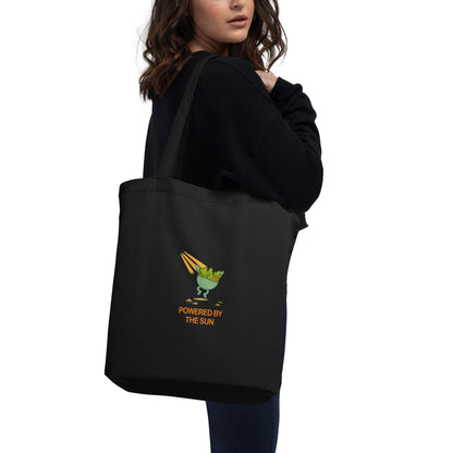 Back view of wid Designs eco tote bag in black, shown on a model.