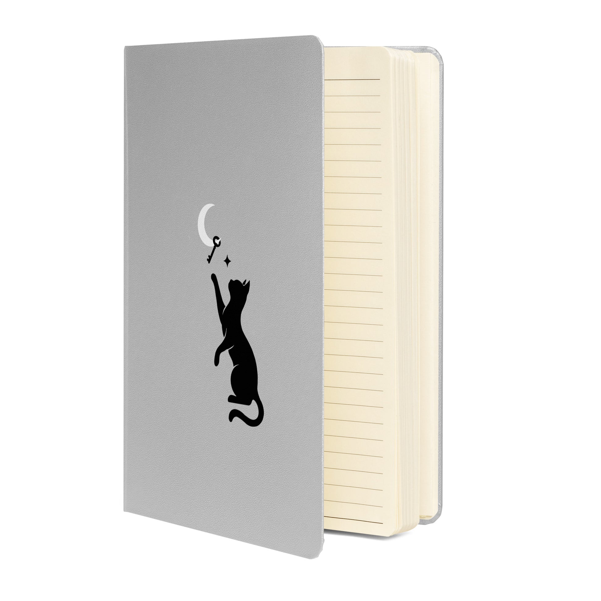 Curious Things hardcover lined notebook opened to show cream-colored pages and the cat and moon on silver cover design.