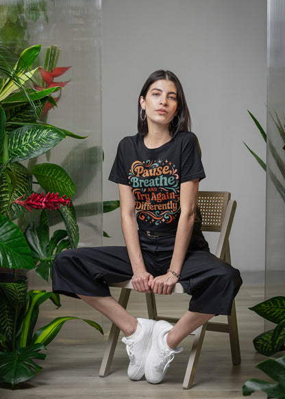 Close front view of the Pause & Breathe colorful retro T-shirt design on model.