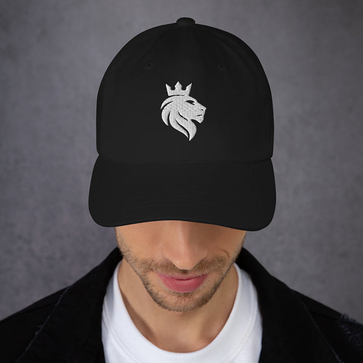 Male model wearing the Still Lion black dad hat, looking downward.